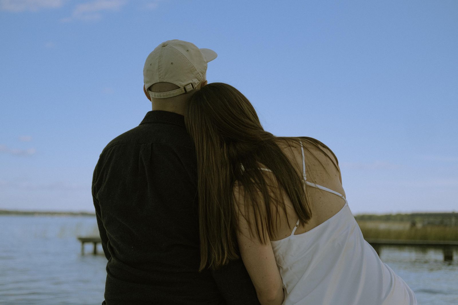 Renee leaning on Peter, looking out over the lake